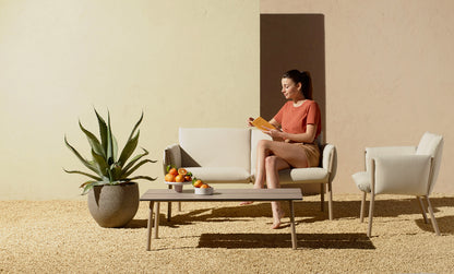 S•CAB Brezza outdoor coffee table paired with matching sofa and lounge chairs in a contemporary garden setting.