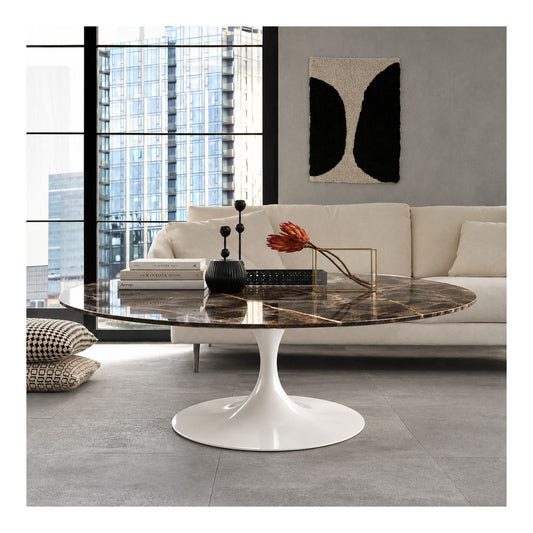 Bronze Imperial Tulip coffee table featuring a polished Bronze Emperador marble tabletop with rich brown tones and striking golden veining, paired with a glossy white tulip pedestal base. Styled in a contemporary living room with a cream sofa, black decorative accessories, floor-to-ceiling windows, and modern artwork, showcasing luxury Italian design for modern, Scandinavian, minimalist, and mid-century interiors.