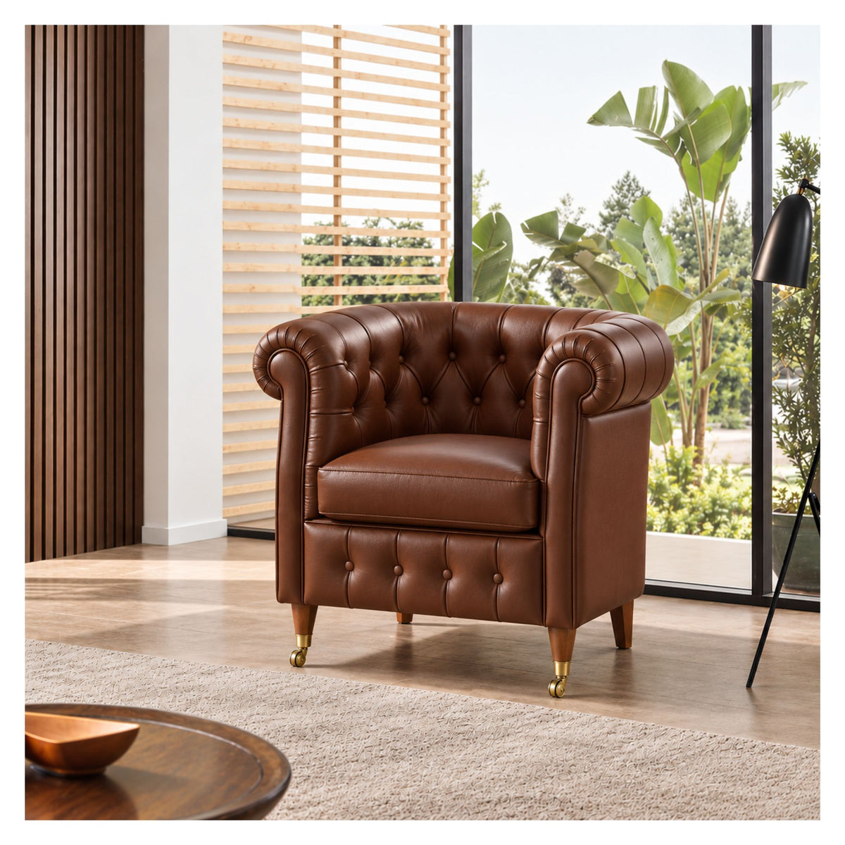 Brown Chesterfield-inspired armchair with rolled arms and brass castors in a bright living room