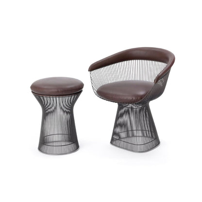 Brown leather Platner lounge chair with a sculptural wire pedestal base and matching upholstered Platner stool, featuring dark metallic steel rod frames in a timeless mid-century modern design.