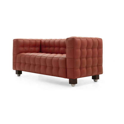 Brown tufted leather cube sofa with deep square quilting and a minimalist geometric silhouette, inspired by iconic Italian modernist furniture, shown on a white background