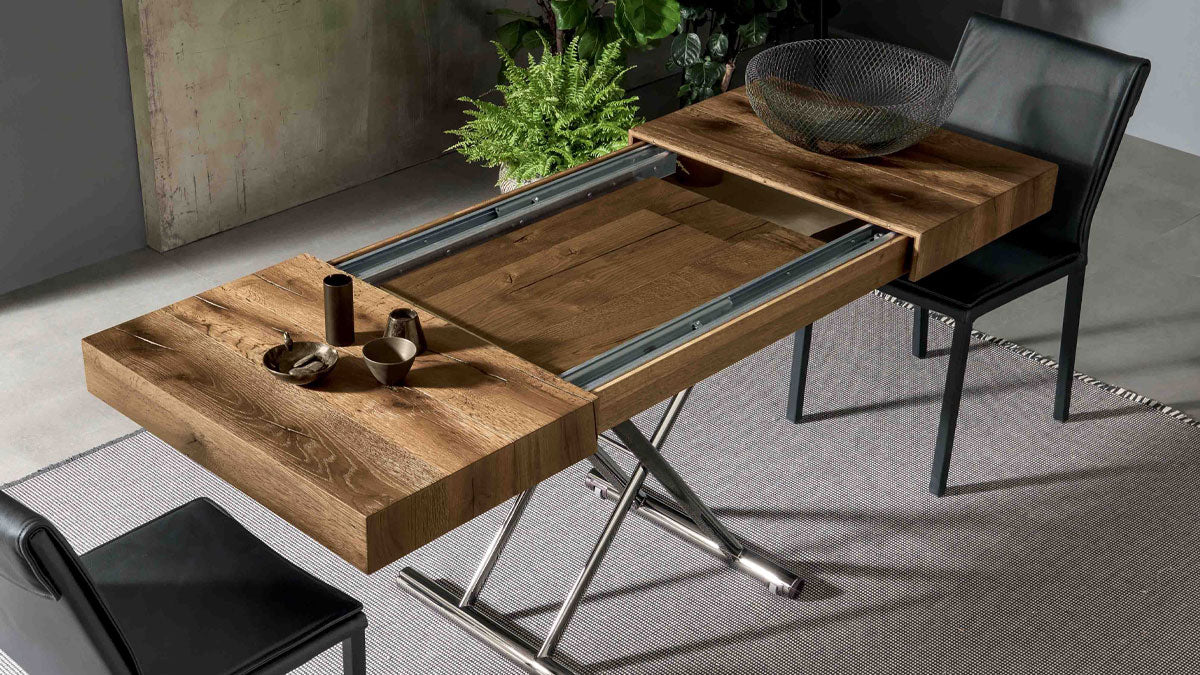 Calypso transforming table by Altacom showing the synchronized opening system and hidden internal extension leaves