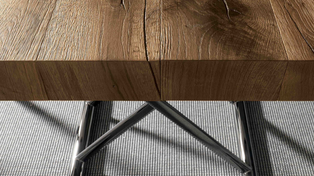 Close-up of the Calypso transforming table by Altacom showing the thick old oak wood tabletop and polished chrome base
