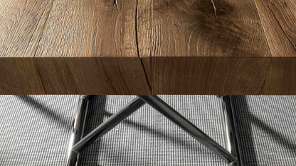 Close-up of the Calypso transforming table by Altacom showing the thick old oak wood tabletop and polished chrome base