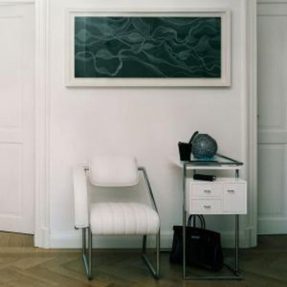 Modern cantilever armchair upholstered in white leather with a polished chrome tubular steel frame, featuring a curved padded armrest, ribbed seat and minimalist Bauhaus-inspired design for luxury dining rooms, executive offices and contemporary interiors.