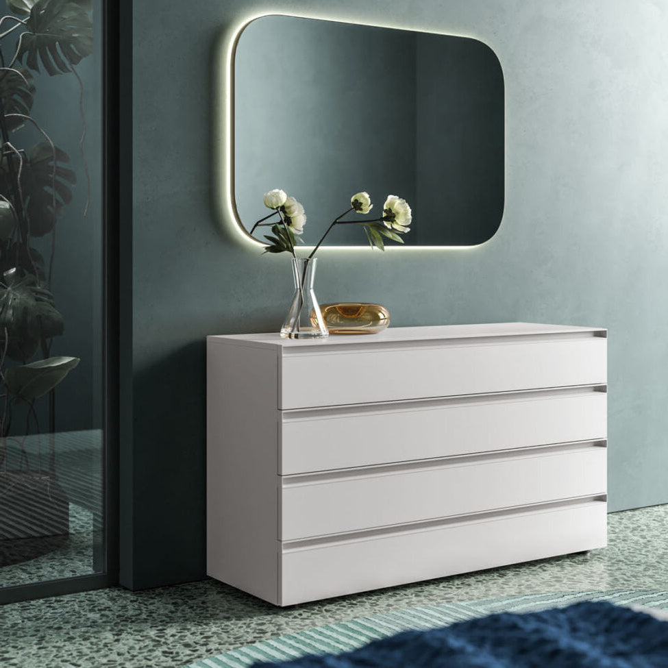 White dresser with a rectangular mirror on a gray wall