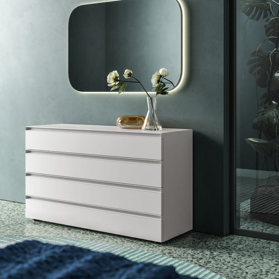 White dresser with a rectangular mirror on a gray wall
