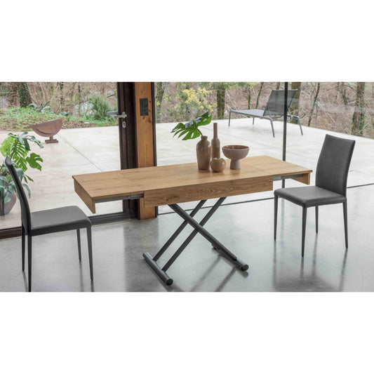 Compact convertible table by Altacom extended into dining table with chairs showing space saving design and X frame base
