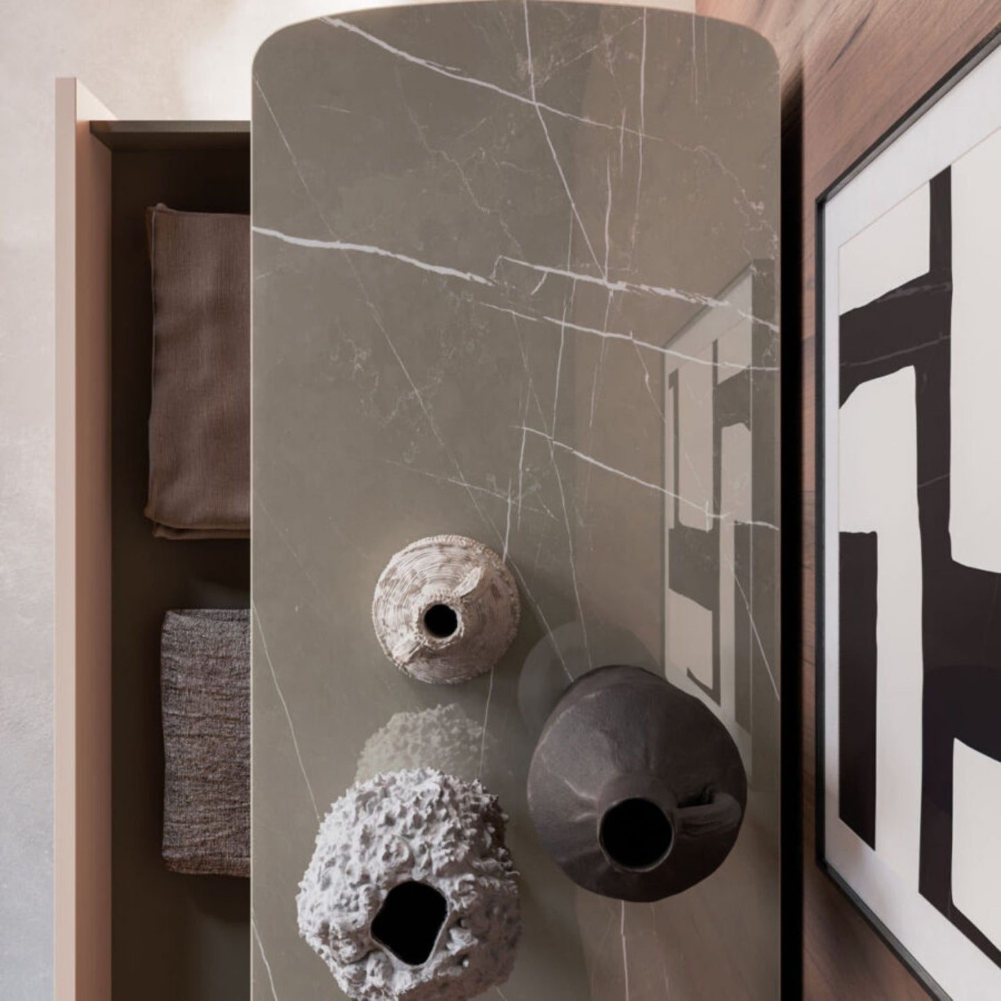 Decorative vases on a marble-patterned surface with a modern interior setting.