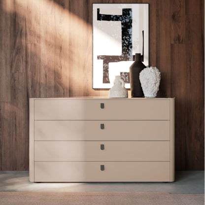 Beige dresser with decorative items against a wooden wall