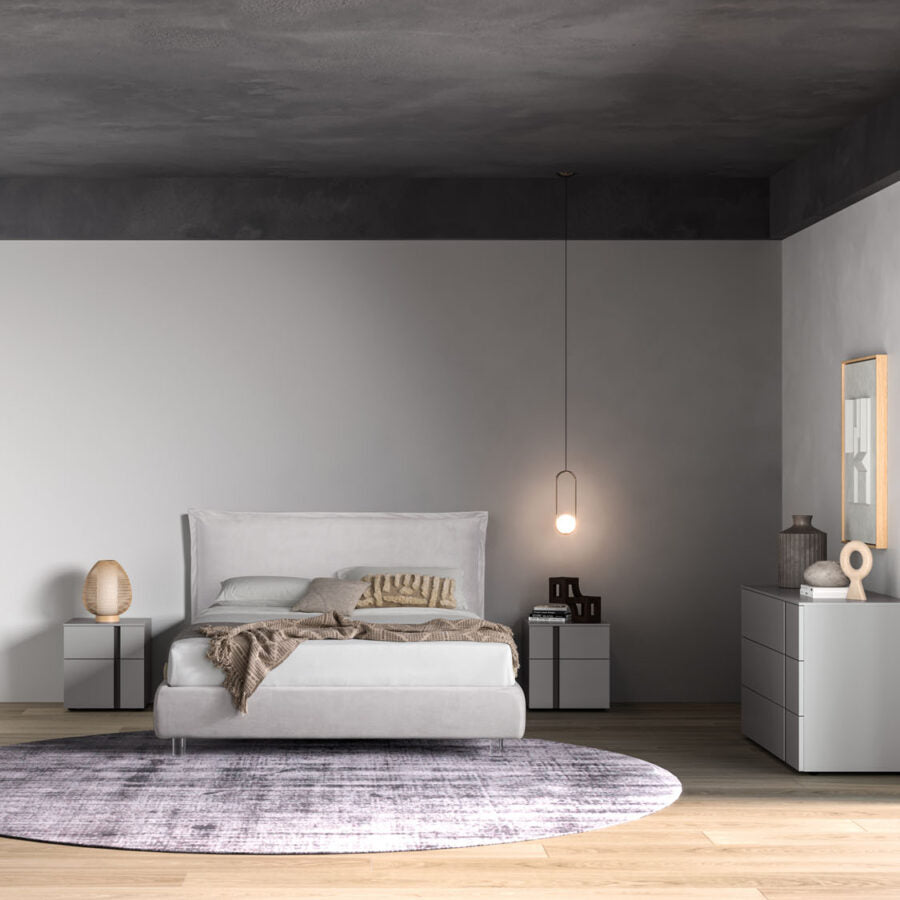 Modern bedroom with a bed, nightstands, and a rug.