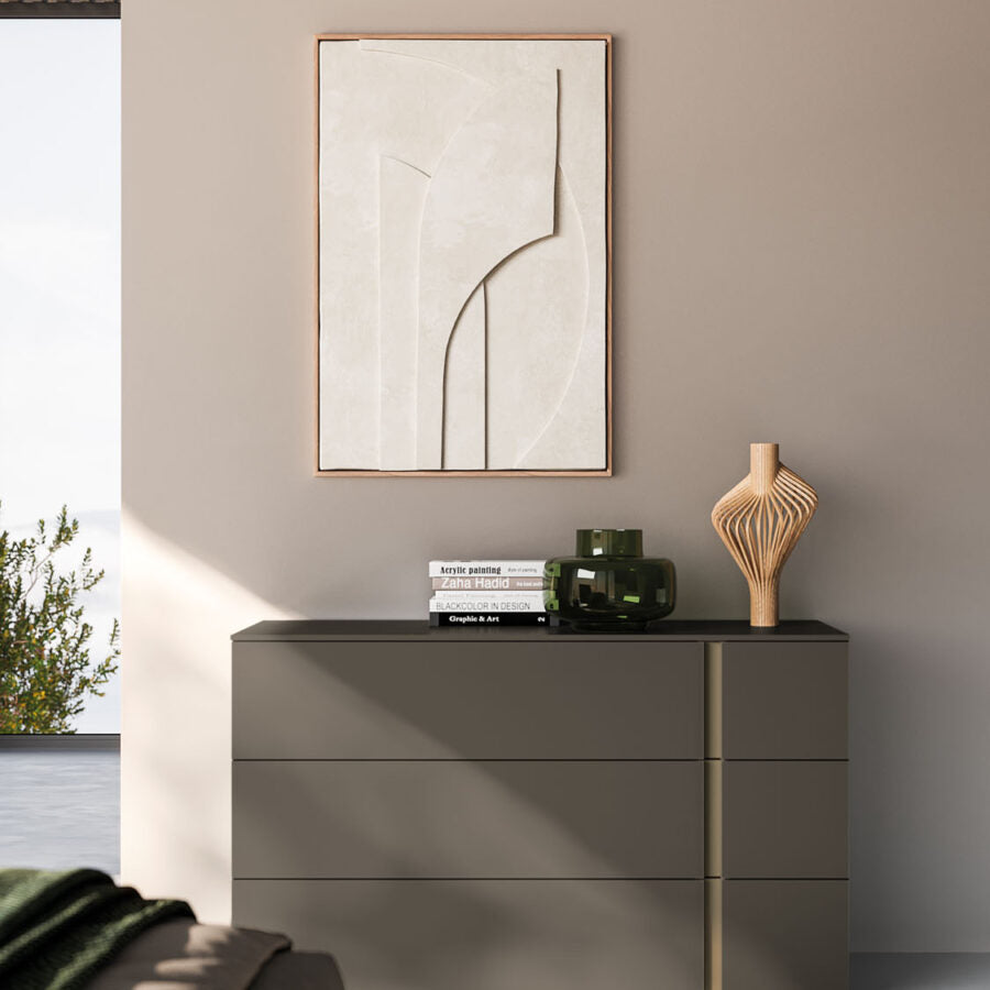 Modern interior with a gray dresser, abstract art, and decorative items.