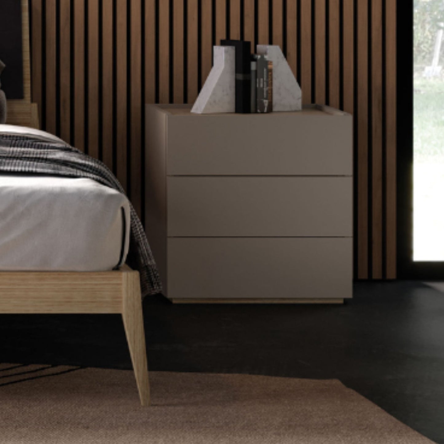 Beige dresser with books and decorative items in a bedroom setting