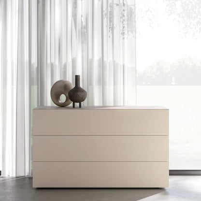 Beige dresser with two drawers against a white curtain background