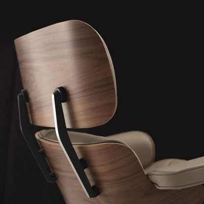 Close-up of the curved wood shell and upholstered back of the CTS Design lounge chair