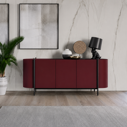 Dall'Agnese Supernova modern sideboard cabinet in deep burgundy with black metal legs, styled in a contemporary living room setting with a gray rug, marble wall, and decorative objects on top.