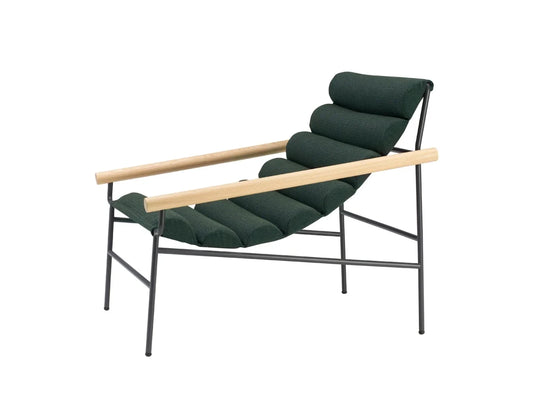 Dress Code Fashion lounge chair with dark green cylindrical cushions, natural wood armrests, and a slim black metal frame.