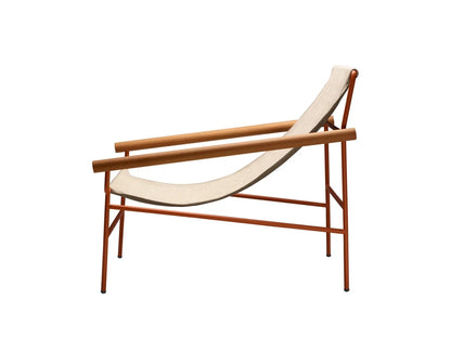 Dress Code Glam 2582 lounge chair with a cream fabric sling seat, warm wood armrests, and a slim terracotta metal frame.
