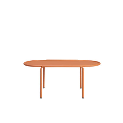Front view of the S•CAB Dress Code Oval Coffee Table featuring a terracotta oval tabletop with a minimalist tubular metal frame.