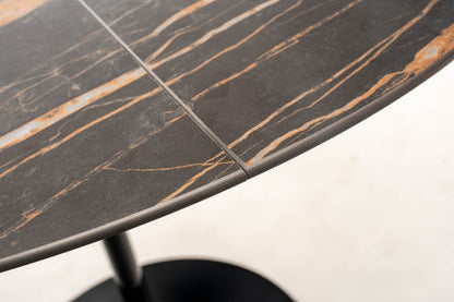 Close-up detail of extendable tulip dining table with Noir Desir ceramic top and gold veining showing extension joint and edge thickness