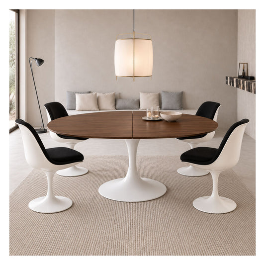 Extendable Tulip dining table with a dark wood top and white pedestal base, surrounded by four white chairs with black seats.