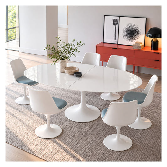 Extendable oval Tulip dining table with a glossy white top and pedestal base, surrounded by white chairs with blue seat cushions.