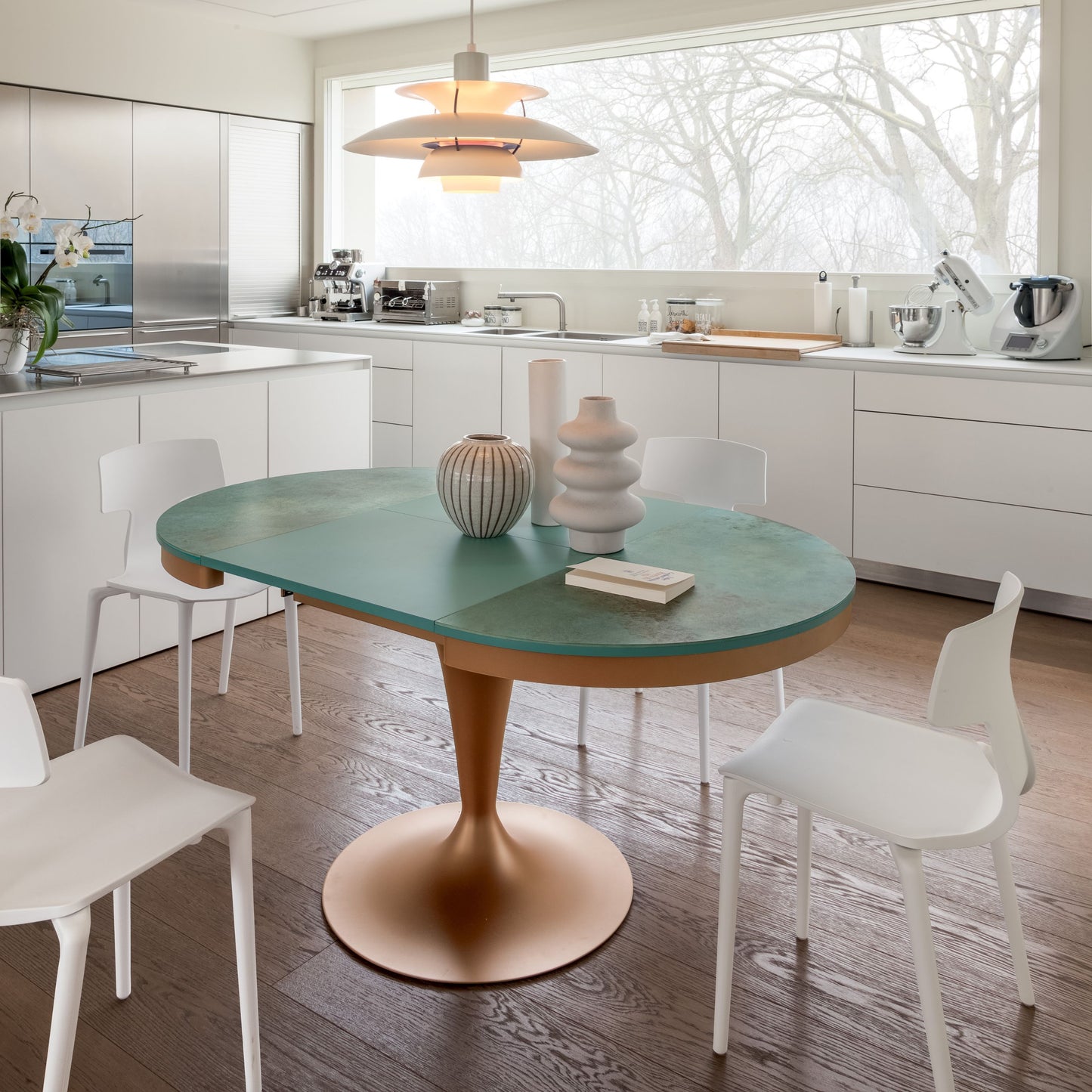 Extendable pedestal table opened to oval shape in contemporary dining room