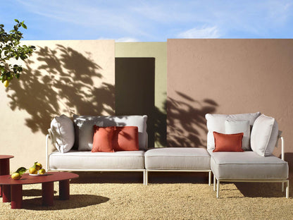 Flap 2902 modular outdoor sofa with cream cushions and terracotta accent pillows arranged on a contemporary patio.