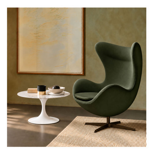 Green Egg lounge chair paired with a white marble Tulip side table featuring a round marble top and white pedestal base in a modern living room.
