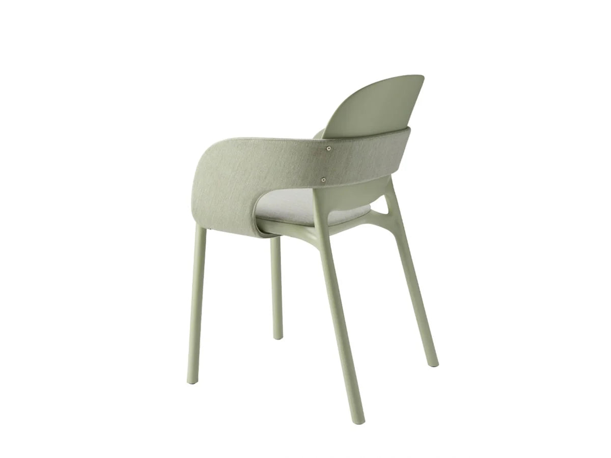 Rear angled view of the HUG 2384 upholstered chair with sage green fabric, matching shell back, and integrated armrests.