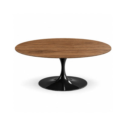 Italian oval medium walnut wood dining table with a glossy black tulip pedestal base on a white background.