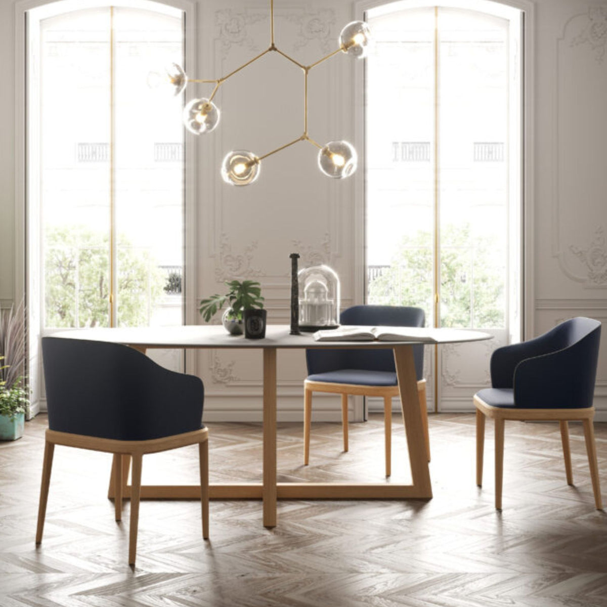 Italian oval white ceramic dining table with a solid oak base and upholstered dining chairs in a contemporary dining room.