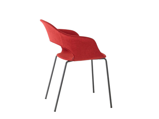 Rear angled view of the S•CAB Lady B Pop Chair with Armrests featuring a coral upholstered shell seat and slim metal legs.