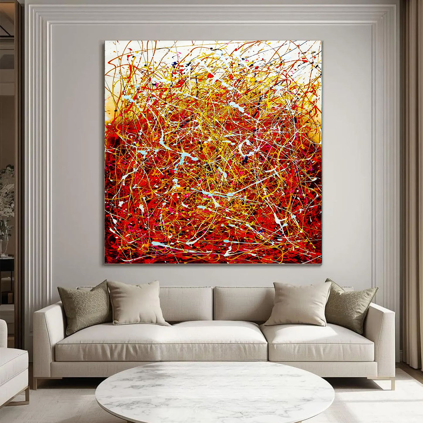 Abstract painting in a living room with a beige sofa and round coffee table.