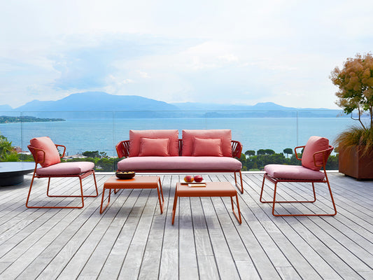 Lisa Club outdoor sofa set with matching lounge chairs and coffee tables on a terrace overlooking the sea.