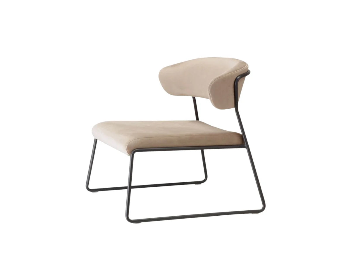 Front angled view of the Lisa Lounge designer armchair with beige upholstery and a slim black sled metal base.
