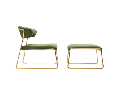 Lisa Lounge designer armchair with matching ottoman in green upholstery and elegant brass sled frames shown in side view.