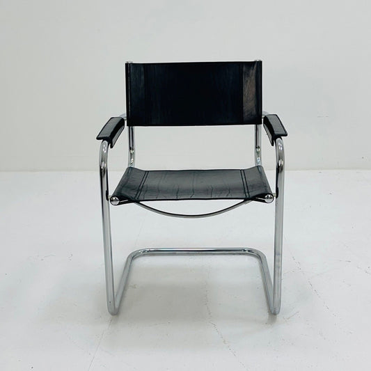 Front view of a Marcel Breuer style cantilever armchair with black leather seat, backrest and arm pads, supported by a polished chrome tubular steel frame for modern dining rooms, offices and contemporary interiors.