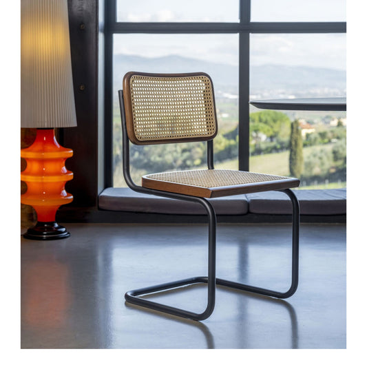 Marcel Breuer style Cesca cantilever chair with natural woven cane seat and backrest, solid wood frame and black tubular steel base, ideal for modern dining rooms, home offices and contemporary interiors.