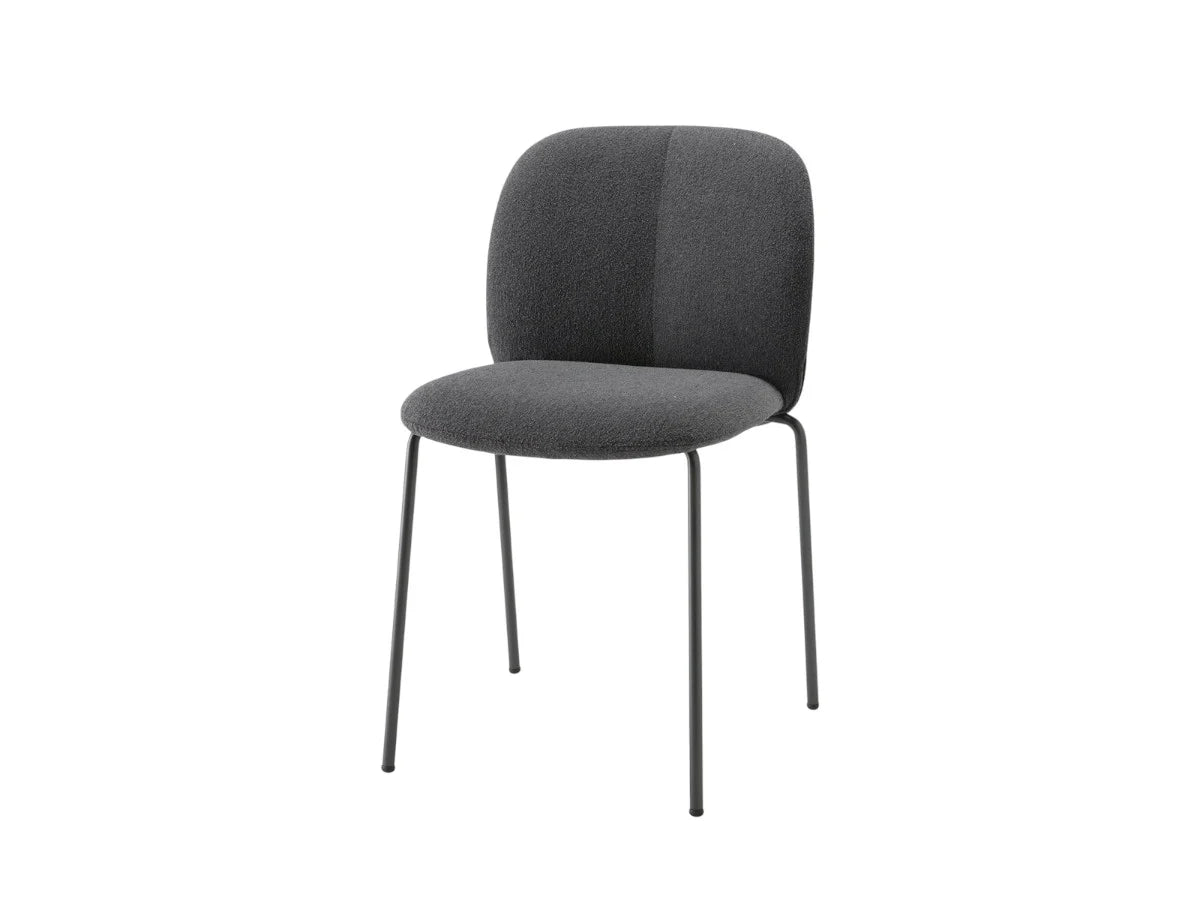 Front angled view of the Mentha Pop 2720 upholstered dining chair with charcoal fabric upholstery and slim dark metal legs.