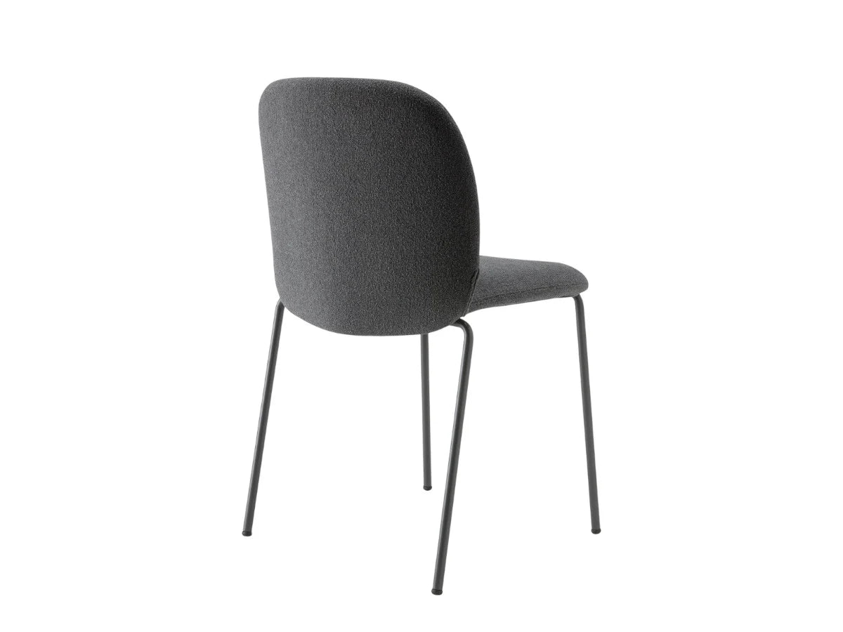 Rear angled view of the Mentha Pop 2720 upholstered dining chair with charcoal fabric upholstery and slim dark metal legs.