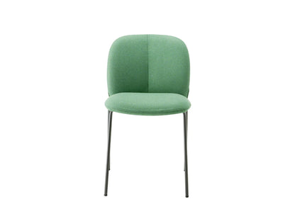 Front view of the Mentha Pop 2720 upholstered dining chair with green fabric upholstery and slim dark metal legs.