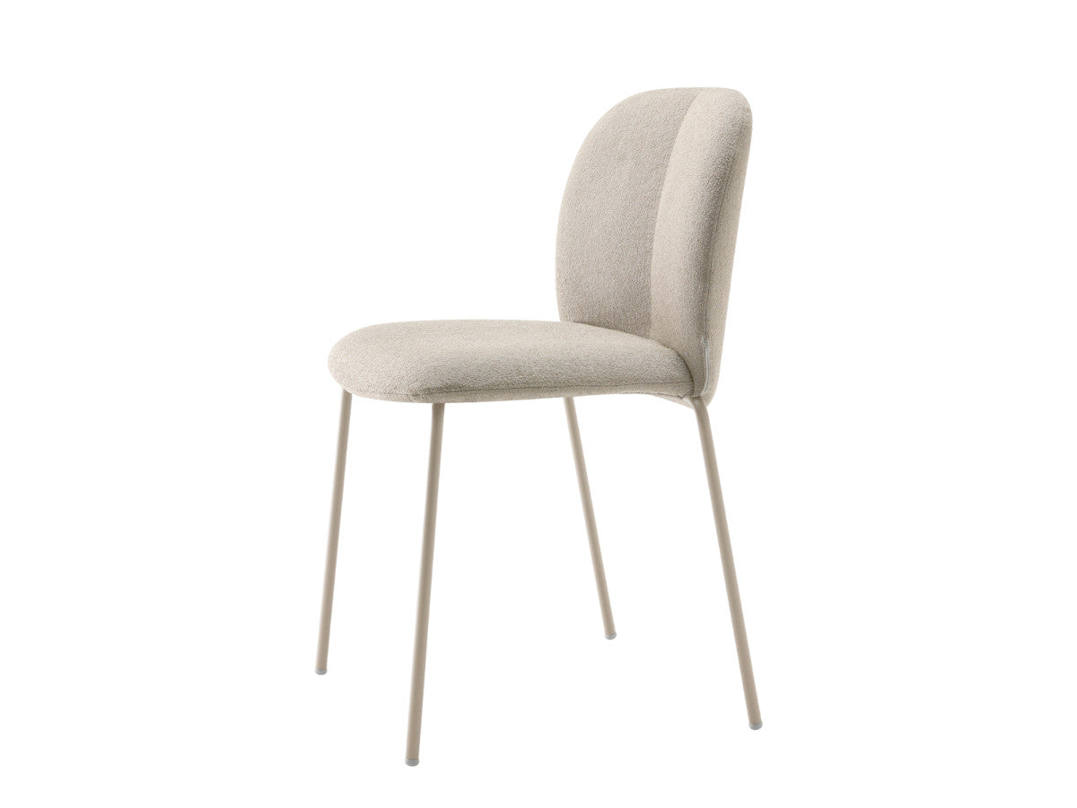 Side angled view of the Mentha Pop 2720 upholstered dining chair with cream fabric upholstery and slim light metal legs.