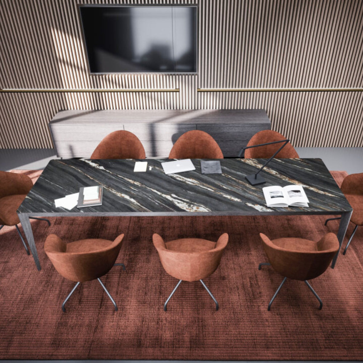 Modern rectangular black marble dining table with grey metal legs, styled in a contemporary dining room with upholstered terracotta chairs and decorative accessories