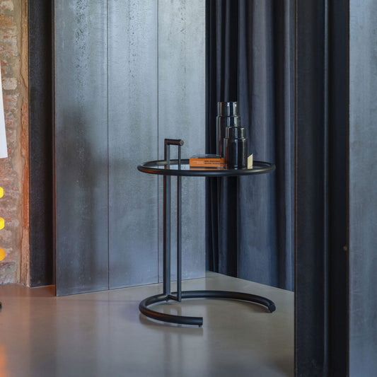 Modern round side table with a matte black metal frame and circular tray-style tabletop, featuring a minimalist tubular steel base, ideal as an accent table for living rooms, bedrooms, lounges and contemporary interiors.