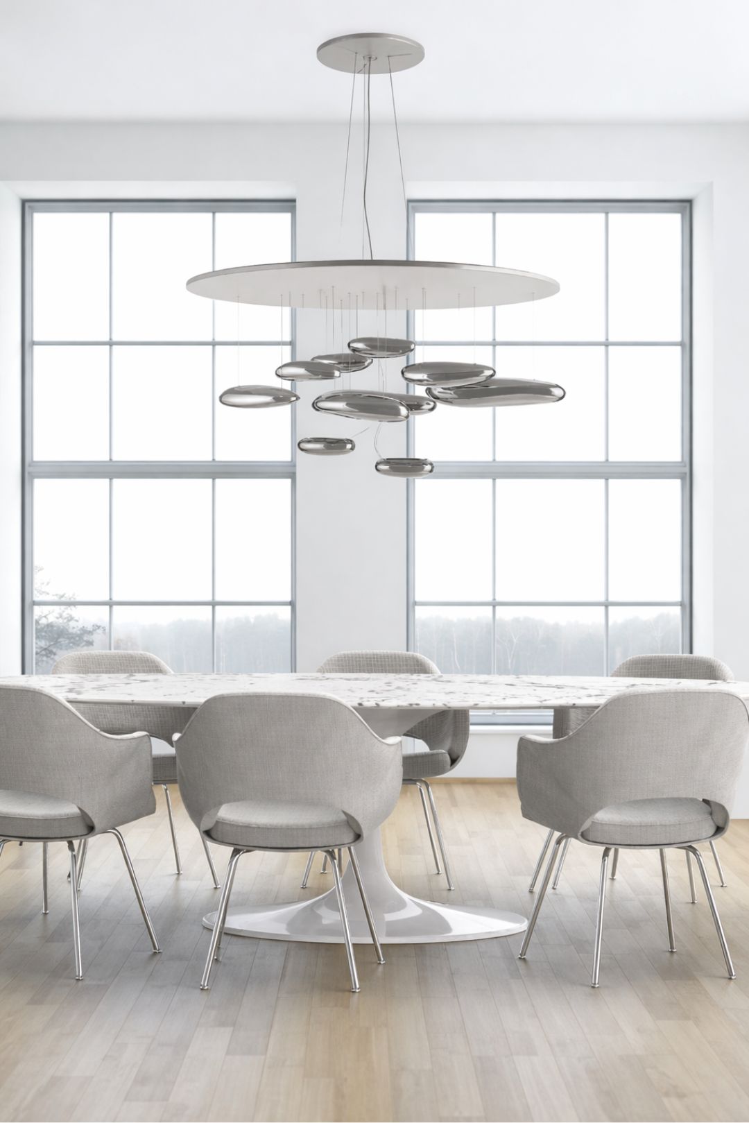 Round tulip dining table with upholstered chairs in a minimalist modern Italian dining room featuring large windows and sculptural ceiling light