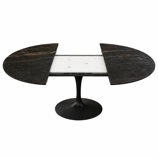 Extendable oval tulip dining table Saarinen style with Noir Desir ceramic black marble effect top and central pedestal base, shown open with extension leaves on a white background