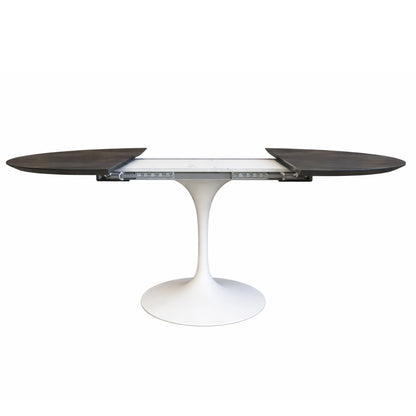Side view of extendable oval tulip dining table with Noir Desir ceramic black top and white pedestal base, showing extension mechanism and separated leaves on a white background