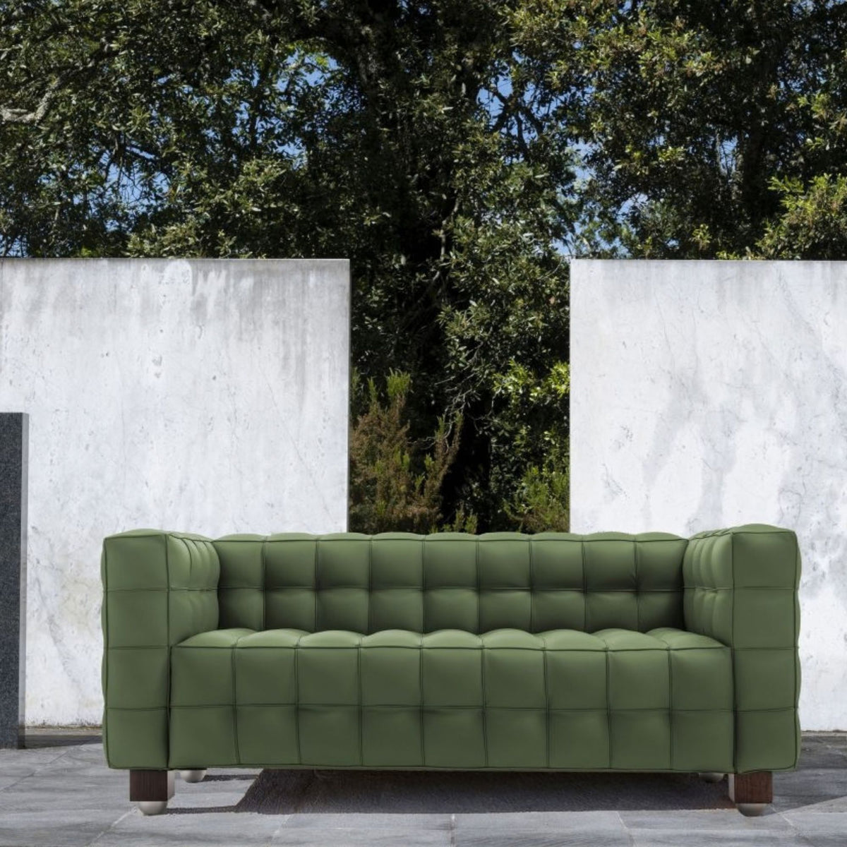Olive green tufted leather cube sofa with deep square quilting and a minimalist geometric silhouette, inspired by iconic Italian modernist design, suitable for contemporary indoor and outdoor living spaces.