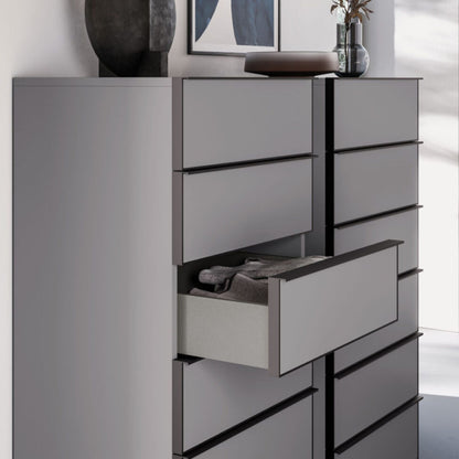 Gray dresser with open drawer against a white wall